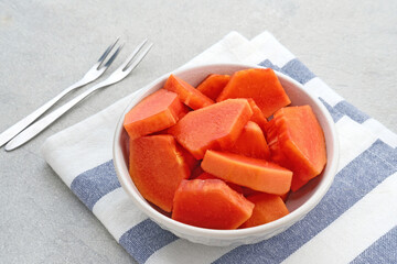 Healthy and fresh cut papaya fruit or sliced ​​papaya, served in a bowl
