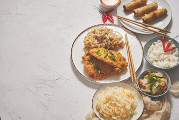 Thai style fried crispy chicken breast in breadcrumbs served with rice noodles