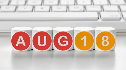 Letter dice in front of a keyboard - August 18
