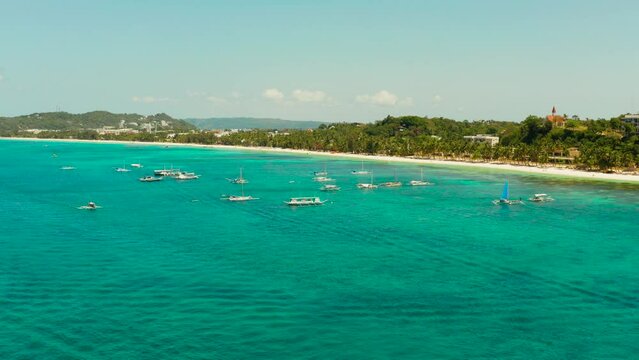 Tropical white sand beach, hotels near the blue lagoon and corall reef. aerial view, Boracay, Philippines. Seascape with beach on tropical island. Summer and travel vacation concept.