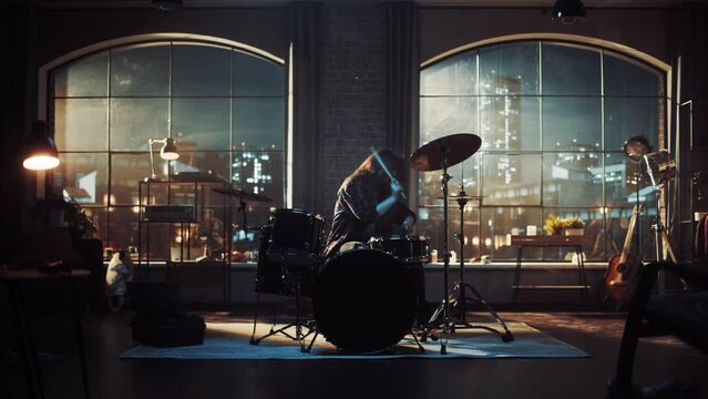 Expressive Drummer Girl Playing Drums in a Loft Music Rehearsal Studio at Night. Rock Band Music Artist Learning a New Drum Solo. Zoom In Shot.