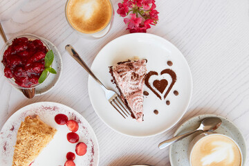 Assortment of natural vegan, layered desserts, piece of cakes with fresh fruits and berries. Celebration, assortment of sweets on the terrace.