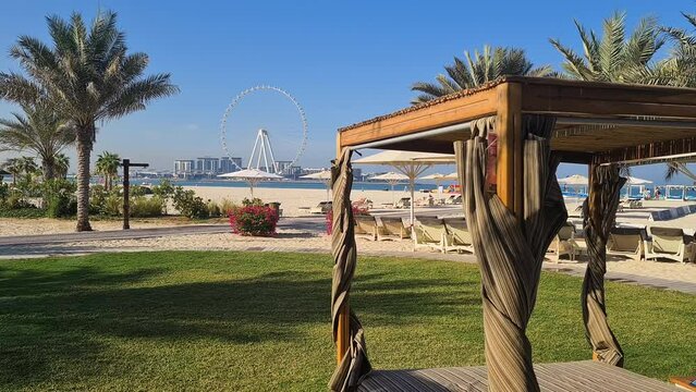 JBR Beach, Dubai, Emirates. Cabanas and Luxury Beachfront With Ferris Wheel and Skyscrapers in Background, Panorama