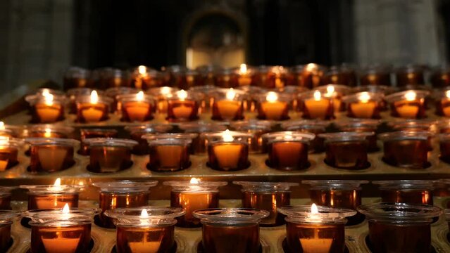 4k video with a lot of candles lit up in a church in memory of the loved ones who died