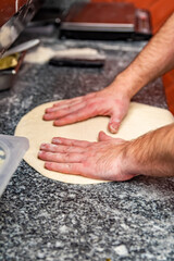 Obraz na płótnie Canvas hand of chef baker making pizza at kitchen. The process of making pizza. cooking italian pizza