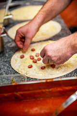 hand of chef baker making pizza at kitchen. The process of making pizza. cooking italian pizza