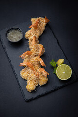 battered shrimp on a dark background