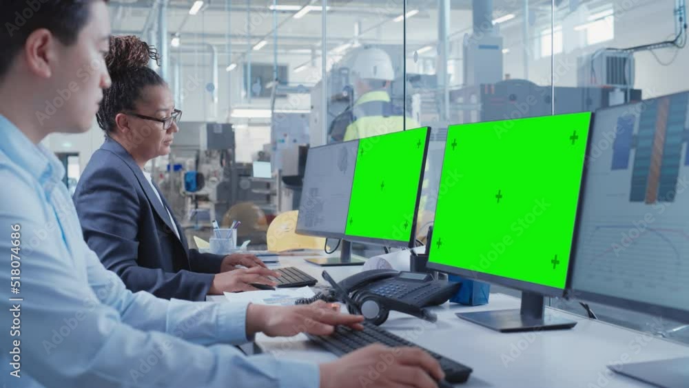 Poster Factory Office Facility: Industrial Engineers Drafting Blueprints of a Heavy Industry Machine Parts on a Computer CAD Software. One Computer Monitor Display is a Green Screen Mock Up Template.