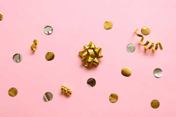 glitter stars and colored confetti flying on pink background