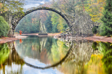 Fabulous autumn landscape in Azalea and Rhododendron Park Kromlau. Rakotz Bridge (Rakotzbrucke, Devil's Bridge)