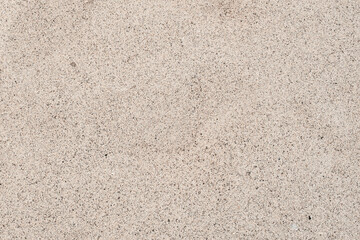 The texture of beautiful coarse sea sand with small pebbles and particles of shells. White sea sand.
