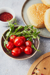 Cherry tomatoes and green pea sprouts in bowl on the table