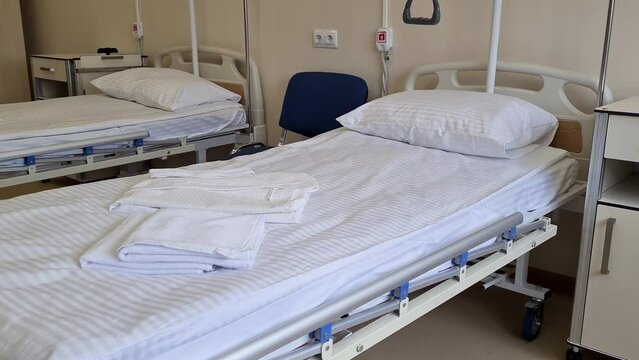 Empty hospital bed for patients. Hospital in patient unit, healthcare concepts