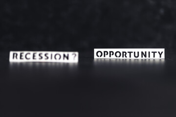 recession or opportunity texts over dark background with only one in focus