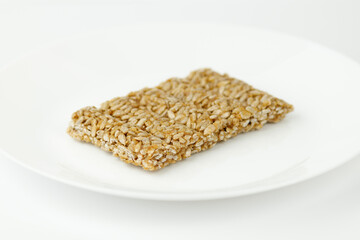 Sweet cereal goats on a white plate. Gozinaki.