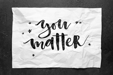 You matter. Lettering on crumpled white paper. Handwritten text. Inspirational quotes.