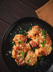 Steak, cauliflower , with cheese , spices, homemade, on a wooden table, dark background, close-up, top view, selective focus, no people,