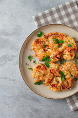 Steak, cauliflower , with cheese , spices, homemade, on a light gray table, close-up, top view, selective focus, no people,