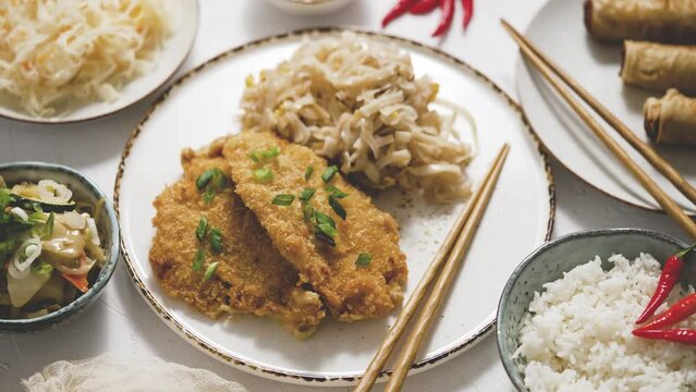 Thai style fried crispy chicken breast in breadcrumbs served with rice noodles