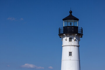 A lighthouse against a blue sky.