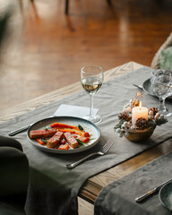 Gourmet restaurant dish with tuna and wine on the table