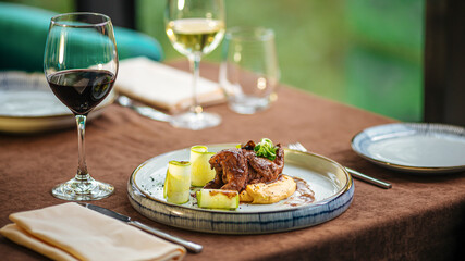 Gourmet restaurant quail dish with puree and red wine