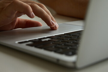 a man working on a laptop, his hands close up