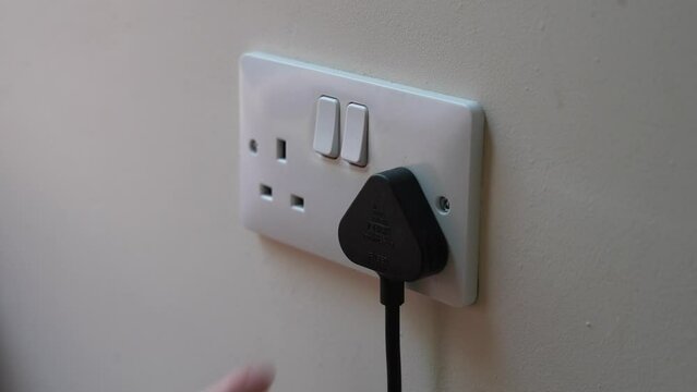White Uk plug sockets being turned off to save electricity and money for the household