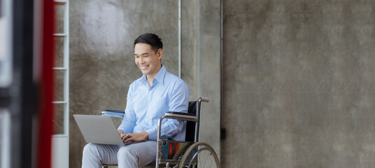 Man sitting on a wheelchair, man with a wheelchair at company office, Working together as a team in...