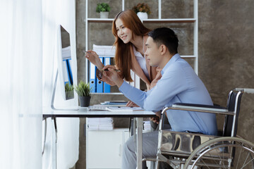 Man sits in wheelchair and brainstorms with colleagues, male and female employees working together...