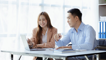 Man sits in wheelchair and brainstorms with colleagues, male and female employees working together in the office, working as a team in a large organization. The concept of team management is diverse.