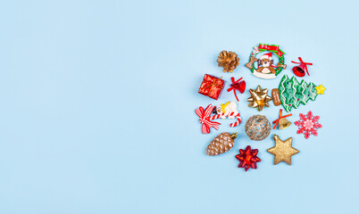Christmas composition. Christmas gifts, decor, toys on a blue background in the form of a circle. Flat lay, top view. Banner with copy space.
