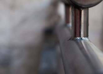 Welded stainless steel railing close-up.