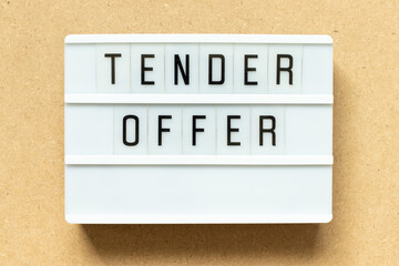 Lightbox with word tender offer on wood background