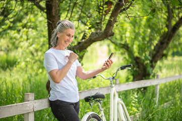 A woman with a bike making selfie and smiling