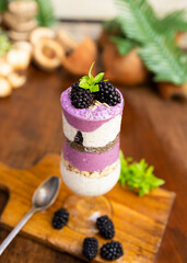 Blackberry smoothies with chia seeds in glass with fresh berries and mint on wooden table