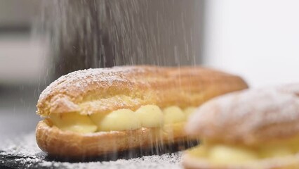 Sprinkling powdered sugar on eclair, slow motion.