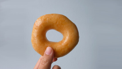 egg, frosted, holding, on dish, homemade, appetizer, dough, meal, topping, nutrition, treat, covered, calories, fat, yummy, donuts, sprinkles, icing, frosting, circle, sweet, dessert, food, hand, eat,