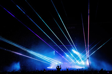 The crowd in an electronic concert with laser lights