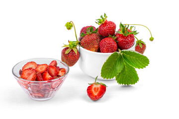 Fresh strawberries, a plate with sliced strawberries on a white background close-up