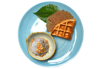 Organic coconut ice cream with waffles on a blue plate 