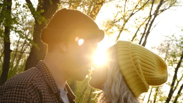 Slow motion 2x Close up portrait of a beautiful young couple waiting to kiss in their traveling time against sunset light