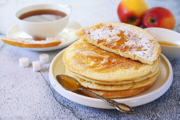 French cuisine. Matefaim. Sweet Apple Pancakes, honey dressing and cup of tea