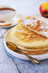 French cuisine. Matefaim. Sweet Apple Pancakes, honey dressing and cup of tea