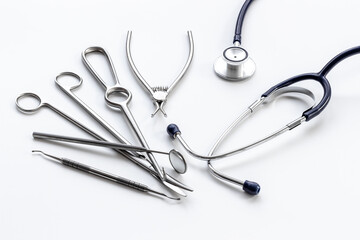 Dental or surgical steel instruments with stethoscope. Healthcare background