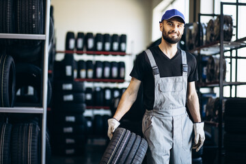 Repairman at car service changing tires