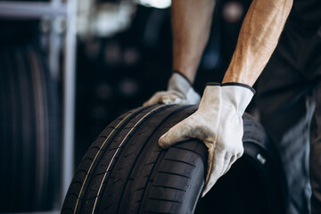 Repairman at car service changing tires