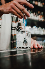 man bartender hand making cocktail in bar