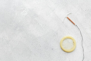 T-shaped intrauterine birth control device with condoms. Contraception concept