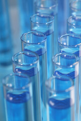 Test tubes with light blue reagents, closeup. Laboratory analysis